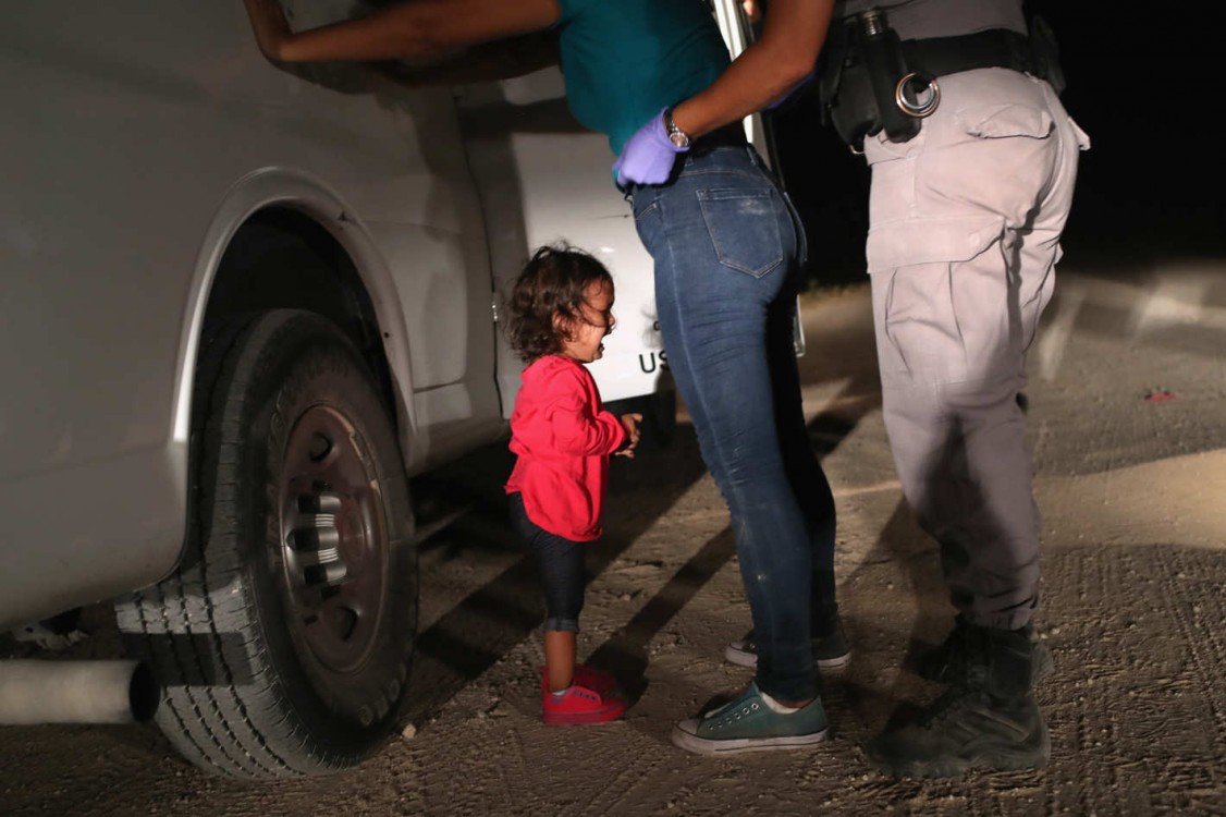 A 2-year-old Honduran asylum seeker cries as her mother is searched and detained near the U.S.-Mexico border on June 12, 2018, in McAllen, Texas. The asylum seekers had rafted across the Rio Grande from Mexico and were detained by U.S. Border Patrol agent