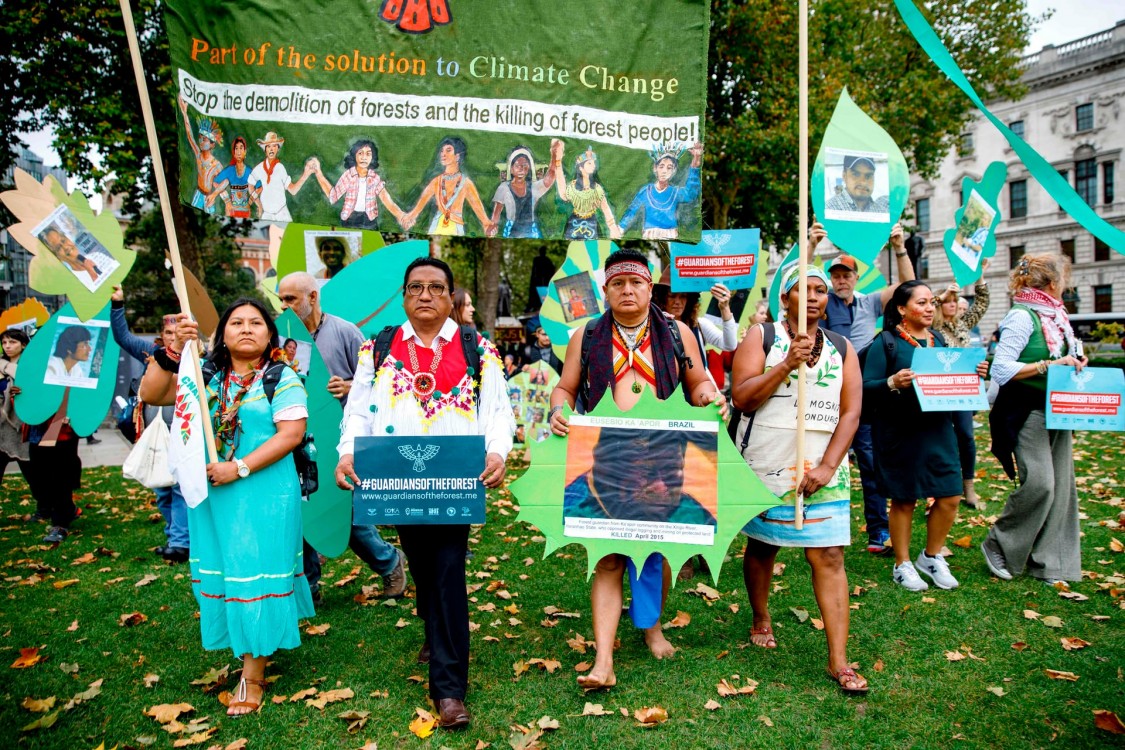 Members of a delegation of indigenous and rural community leaders from 14 countries in Latin America and Indonesia, the Guardians of the Forest campaign, demonstrate against deforestation in London. Photograph: Tolga Akmen/AFP/Getty Images
