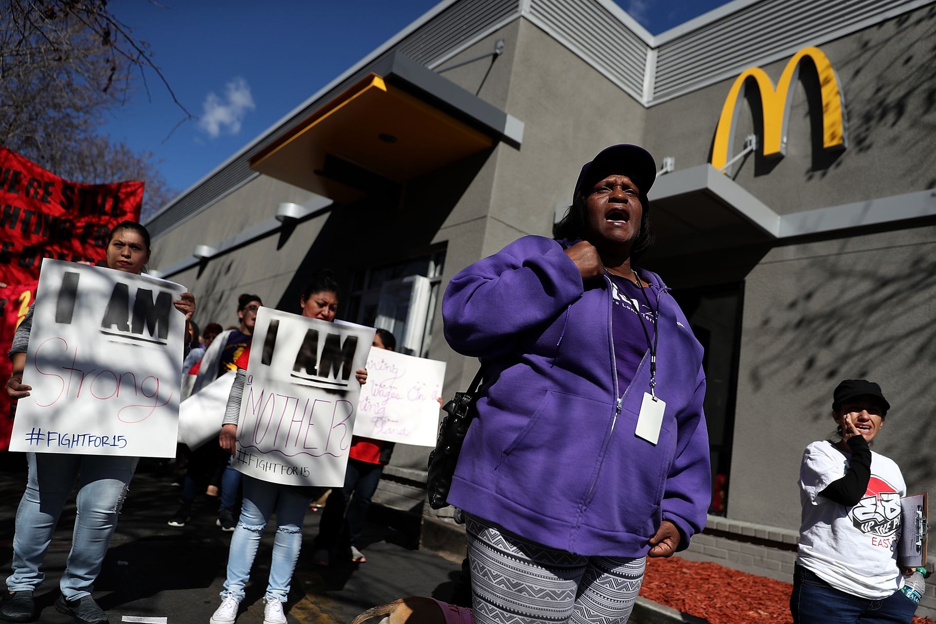 Fast-food workers and union members carry signs as they stage a protest outside of a McDonald's restaurant on February 12, 2018, in Oakland, California. Justin Sullivan/Getty Images