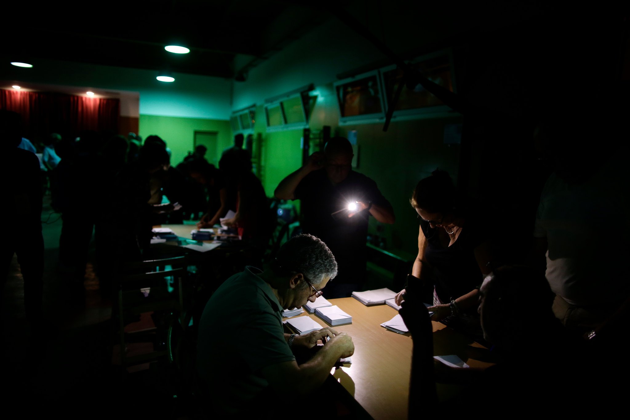 Counting votes during a power outage at a school assigned to be polling station by the Catalan government in Barcelona. Credit Manu Fernandez/Associated Press