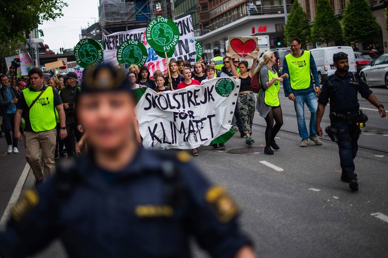 Greta Thunberg (2ndL behind the banner), the 16-year-old Swedish climate activist, marches during the "Global Strike For Future" movement on a global day of student protests aiming to spark world leaders into action on climate change in Stockholm, Sweden 
