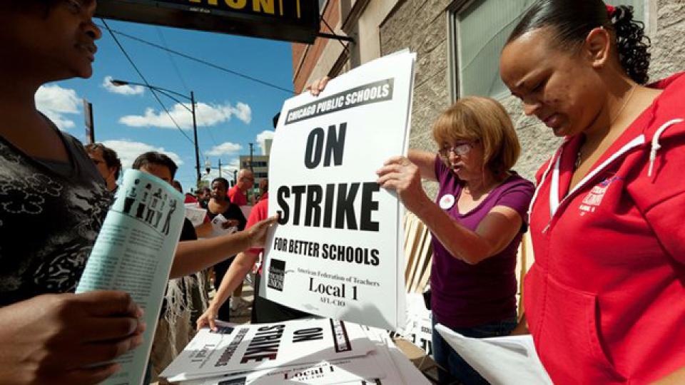 Sitthixay Ditthavong Photo2: Chicago Teachers Union President Karen Lewis, right, tells reporters at a news conference outside the union's headquarters that the city's 25,000 public school teachers will walk the picket line Monday.